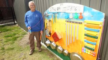Bayside Men's Shed volunteer Fred Poole with the music wall he has built for the students at St Francis Xavier Catholic Primary School at Arncliffe. Picture: Chris Lane