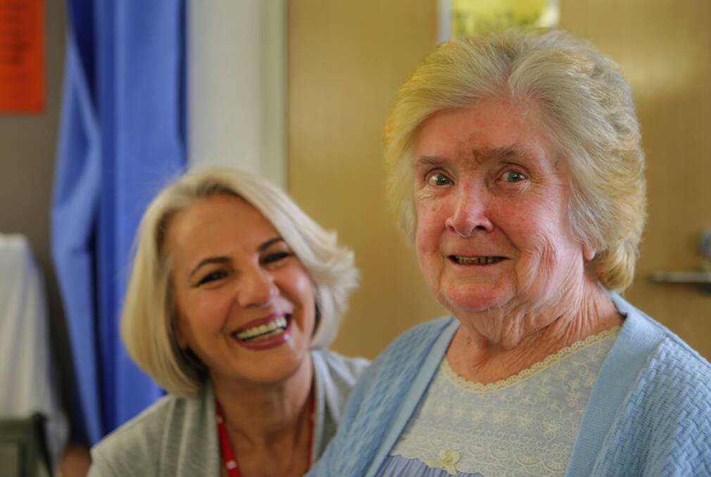 Volunteer: Hairdresser Ninette Manassa (left) offers her skills to patient Eileen Harlow. Picture: John Veage