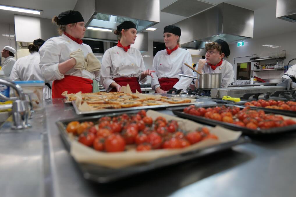 Hospitality students at St Aloysius Cronulla prepare their meal game plan in a culinary cook-up, attended by executive chefs and guests. Picture supplied