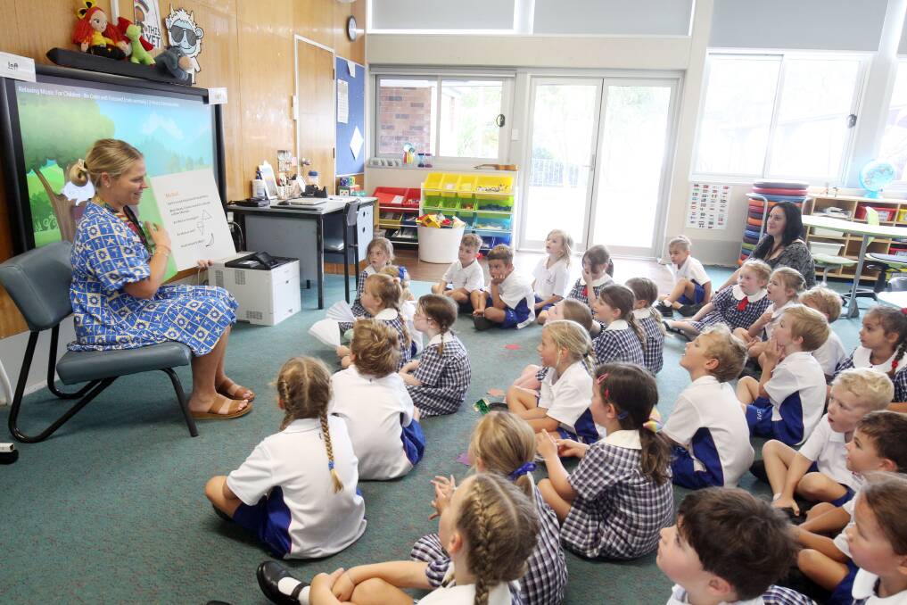Cronulla South Public School teacher Jen Palmervale welcomes her new pupils to their Kindergarten classroom. Picture by Chris Lane

