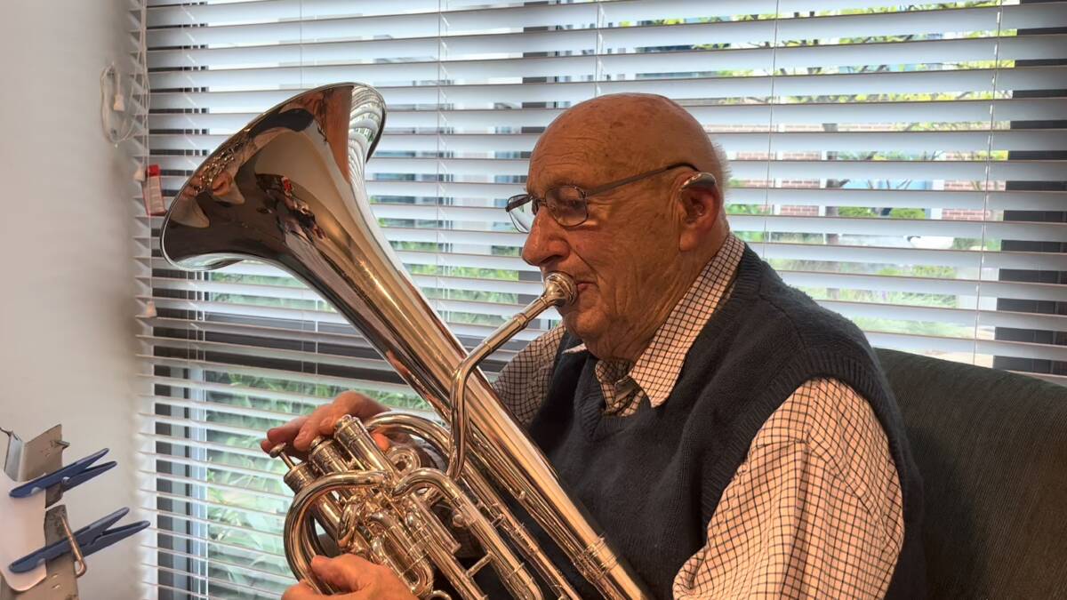 Ron Lee celebrates his 100th by playing a birthday tune. Picture supplied