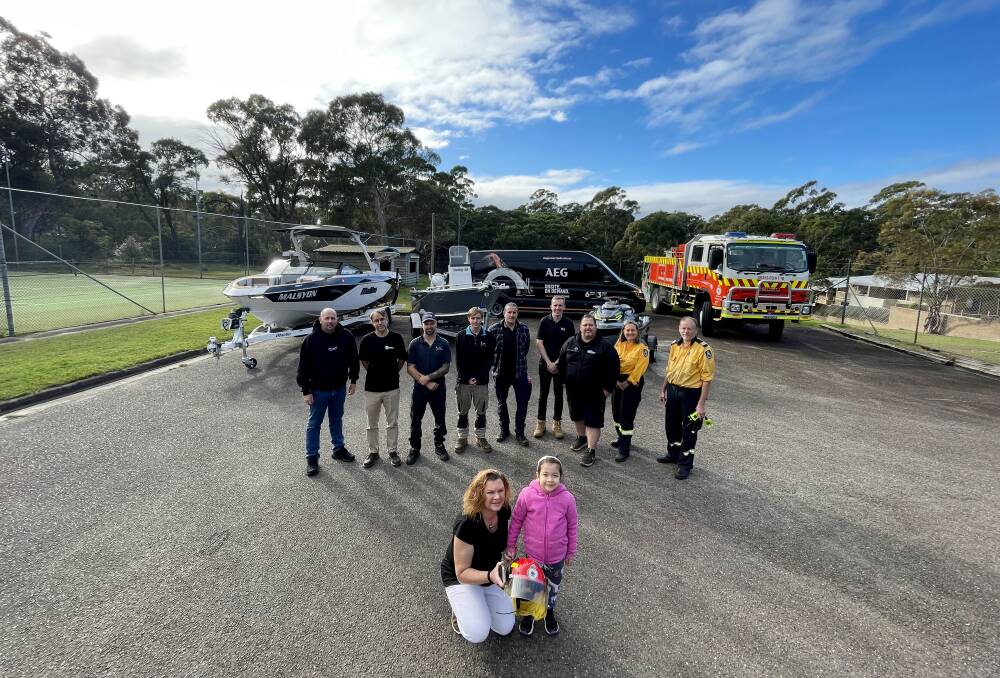 Leesha Cooke pictured with Esther Ying Goodwin, 5, and some of the supporters of a Kirrawee community fundraiser that is returning in 2024. Picture by Chris Lane