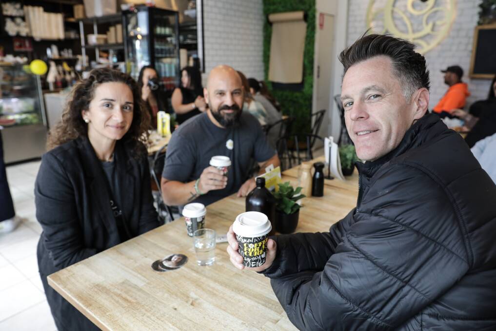 Sue-Ellan and Marino Vasiliou catch up over coffee with NSW Premier Chris Minns, who was at Cure Cafe South Hurstville on September 22 to support the 'coffee for a cure' cause, a project of Little Legs Foundation, established in memory of Alegra Vasiliou. Picture by John Veage