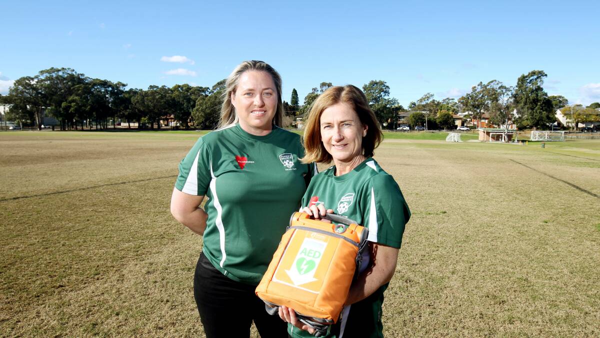 Heartfelt donation: Kylie Richardson (right) and Rebecca Nolan with the defibrillator purchased for Forest Rangers FC at Peakhurst following the death of Kylie's husband Matthew in 2014. Picture: Chris Lane