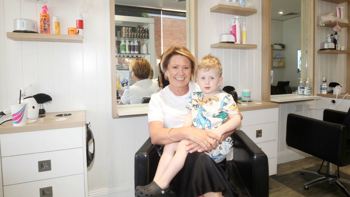 Leigh Anne Brosens, with grandson Axel, in the Engadine salon she opened 33 years ago. Picture by Chris Lane