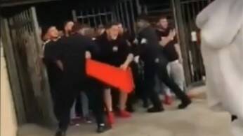 A man prepares to throw a plastic crate during the brawl. Picture: Facebook