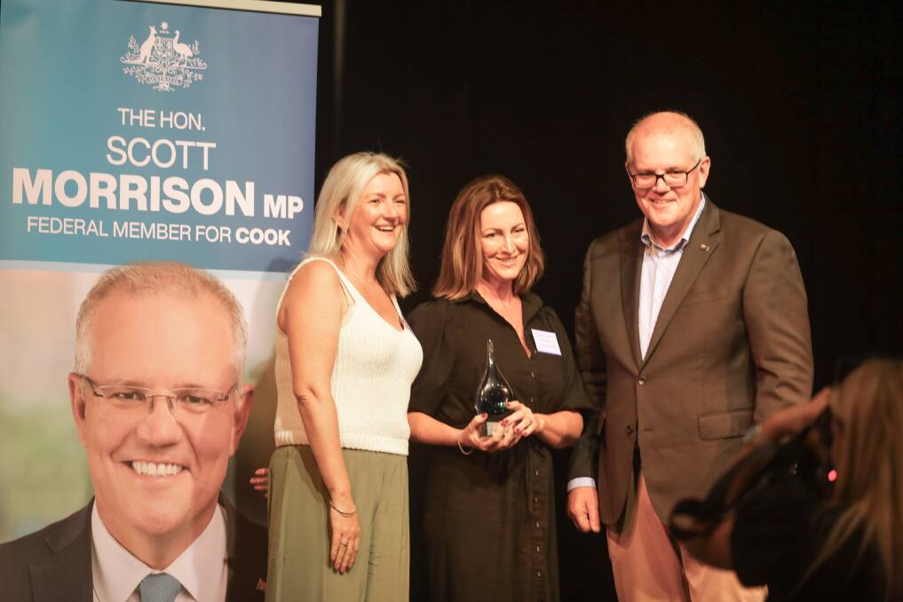 John and Lynn Bell's daughters receive the Cook Community Medal on behalf of their parents from Scott Morrison. Picture by John Veage
