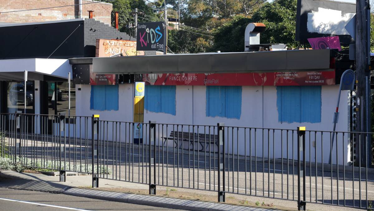 The Mike's Grill and Bar site boarded up after the fire. Picture: John Veage