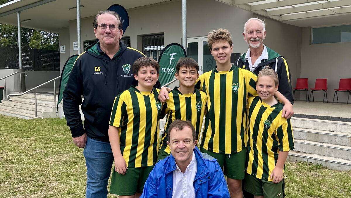 Mark Speakman shares the news of a grant with Lilli Pilli Football Club president Greg Storey (left), player development director Andy Read and U/13 club players. Picture supplied