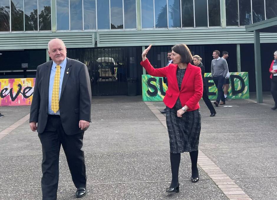 Good news bearer: Gladys Berejiklian, with Lee Evans, waves to students during a quick stopover to announce the awarding of a tender for the new hall. Picture: supplied