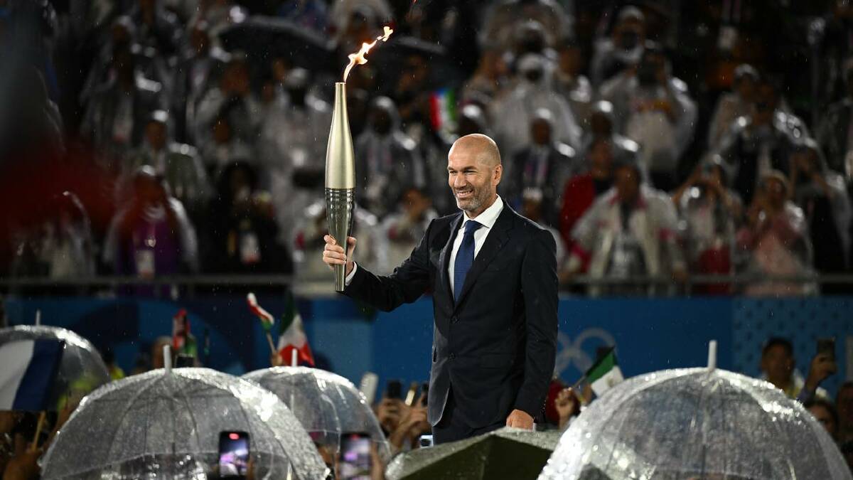 French soccer star Zinedine Zidane carried the Olympic flame into the Trocadero in Paris. (Dan Himbrechts/AAP PHOTOS)