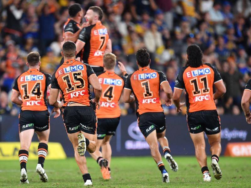 The Wests Tigers fans celebrate after victory in the NRL Grand