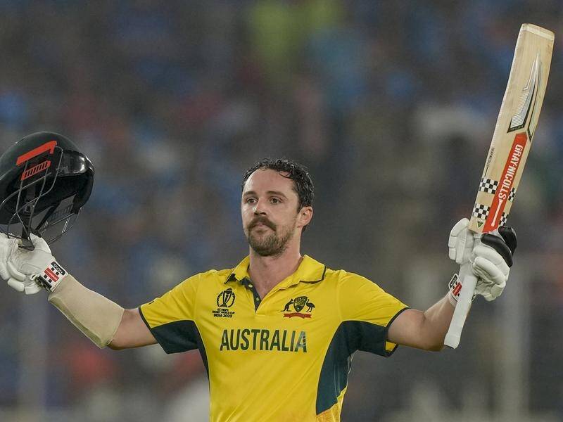 Travis Head raises his bat to celebrate his ton in Ahmedabad amid one of the great World Cup knocks. (AP PHOTO)