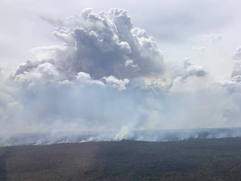 NSW crews have controlled some pockets of a huge bushfire that's created its own weather system. (HANDOUT/NSW RURAL FIRE SERVICE)