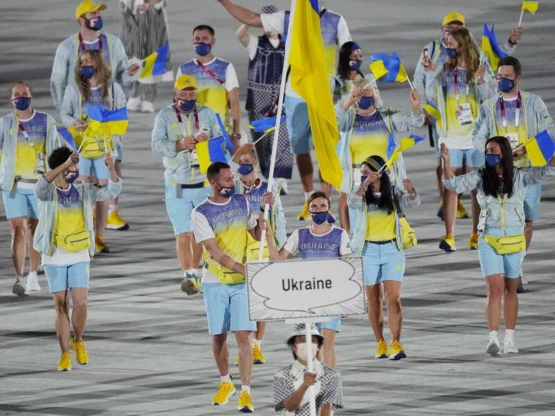 Ukrainian athletes, pictured at the 2020 Olympics opening ceremony, are to get more financial aid. (AP PHOTO)