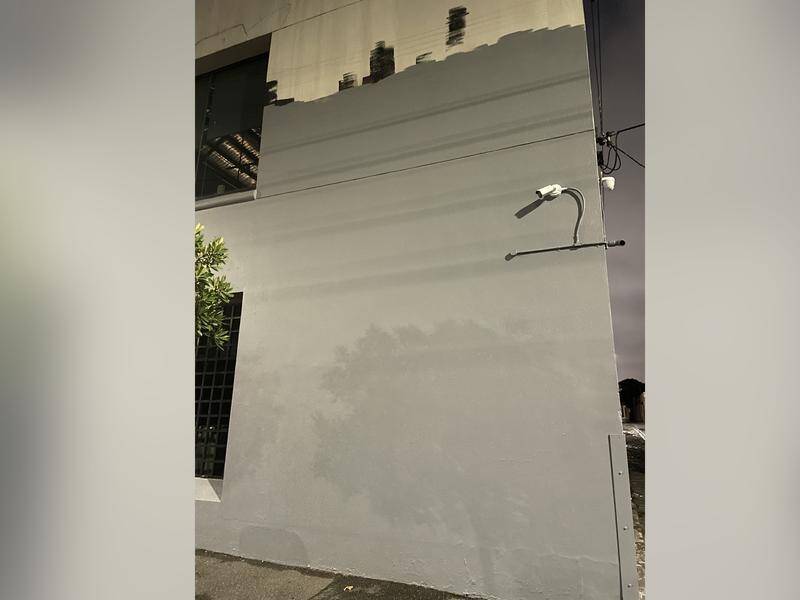 A bare wall is all that remains at Our Community House after a Tarryn Thomas mural was pulled down. (Oliver Caffrey/AAP PHOTOS)