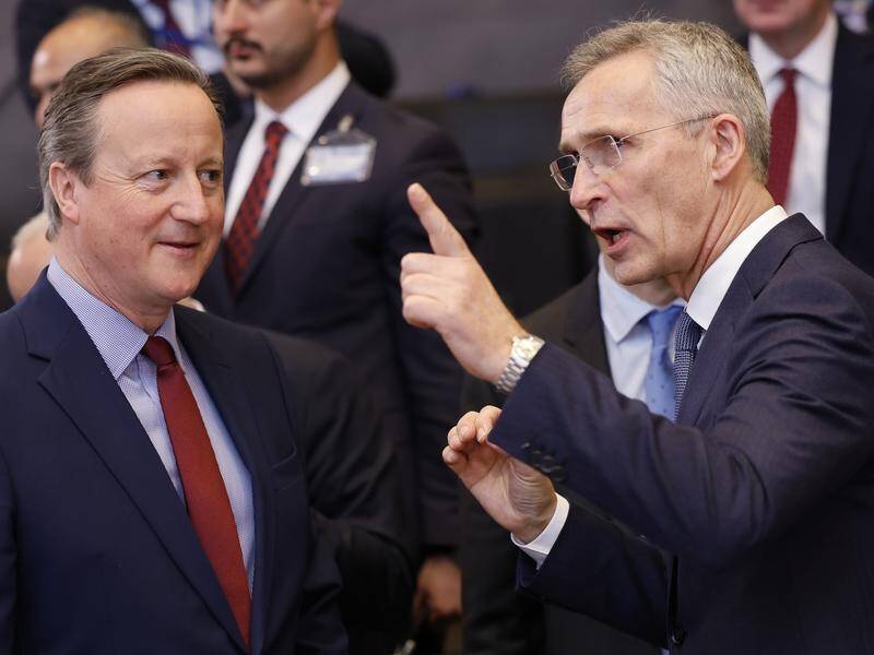 British Foreign Secretary David Cameron (left) is among NATO foreign ministers meeting in Brussels. (AP PHOTO)
