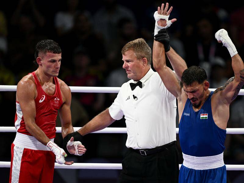 Harry Garside  (left) is shattered after losing his round of 16 bout to Hungary's Richard Kovacs. Photo: Dan Himbrechts/AAP PHOTOS