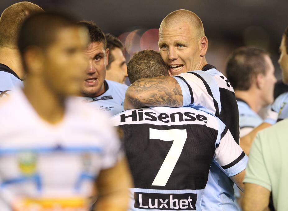 We did it: Luke Lewis embraces halfback Jeff FRobson. Picture: Anthony Johnson