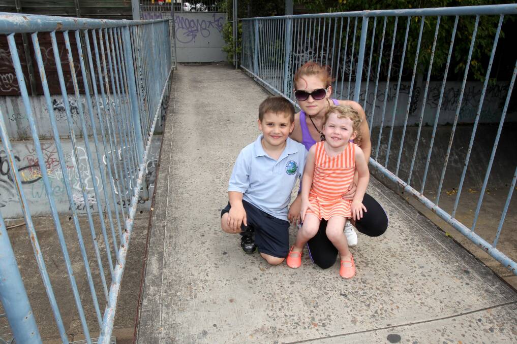 Close call: Serena Solbiati with children Dion and Lily, of Rockdale, next to broken handrailing on a footbridge which has been the subject of numerous complaints to the council.Picture: Lisa McMahon