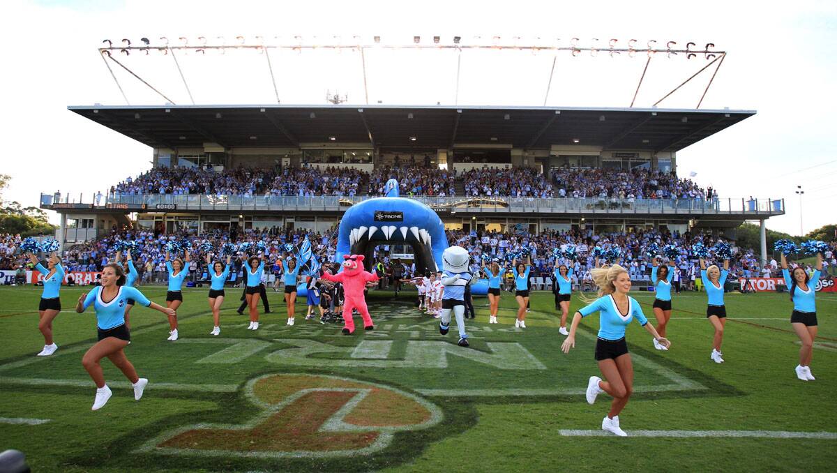 The Sharks start the season off with a win-The Mermaids lead the players out.Picture Chris Lane